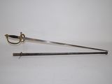 an old sword with a wooden handle on a white surface