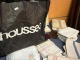 a black bag sitting on top of a table next to a pile of folded towels