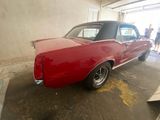 an image of a red car parked in a garage