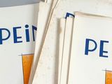 three books with orange and blue designs are stacked on top of each other