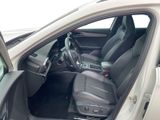 the interior of a car with the door open and the driver ' s seat down