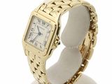 an image of a gold wrist watch with roman numerals on it