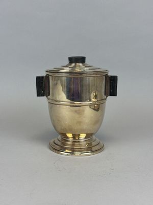 an antique silver plated teapot with a black lid and a black handle