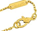 a close up of a gold bracelet with a tag on it