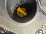 a close up of a metal pipe with a yellow substance in it