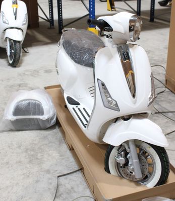 un scooter posé sur une caisse dans un garage