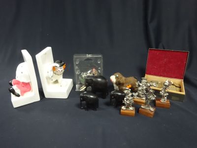 several figurines of animals are displayed on a black background