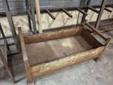 a wooden bed that is sitting in the middle of a room