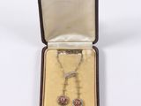 an image of a box with a necklace and a pair of earrings