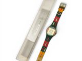 a watch that is sitting next to a pen
