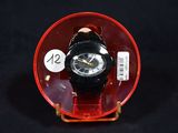a watch sitting in a red case on a black surface