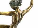 bronze statue of a woman on a surfboard on a white background