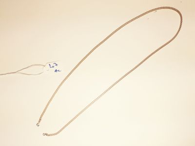 a necklace that is laying on a table next to a pair of scissors