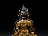 an image of a gold statue of a buddha on a black background