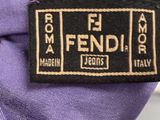 the label is on a purple tie with a black and white design