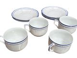 six white and blue coffee cups and saucers sitting on a white surface