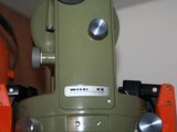 a close up of a green and orange sewing machine