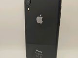 a close up of a black iphone on a white surface