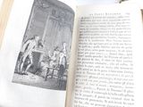 an open book with a picture of a man and a woman sitting at a table