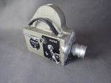 a silver camera sitting on top of a gray table