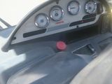 a car dashboard with gauges and a phone in it