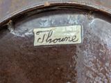 a close up of a metal plate with a name on it
