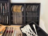 many different types of spoons and forks in a box