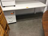 an image of a white desk with drawers in a room