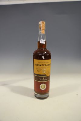a close up of a bottle of whisky on a table