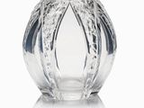 a glass vase that is sitting on a white surface