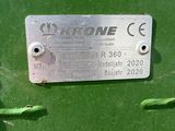 a close up of a metal plate on a green machine