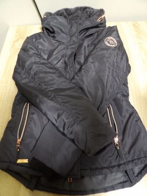 the jacket is black and has gold zippers on the sleeves