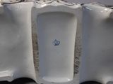 a white porcelain urinal with a blue apple on it