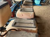 several lawn mowers are lined up in a row in a garage