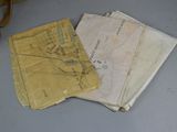 three old maps are sitting on a table next to a pair of shoes