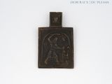 a small metal plaque with a picture of jesus on it