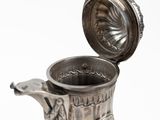a silver vase with a handle on a white background