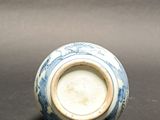 a blue and white vase sitting on a table