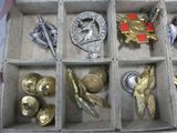 a box with many different types of badges in it