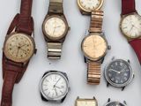 a lot of watches that are sitting on a table