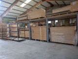 a large warehouse with a lot of boxes and pallets of wood