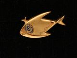 une broche en forme de poisson rouge ornée d'un motif en spirale