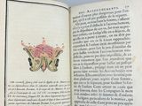 someone is holding a book with a drawing of a butterfly on it