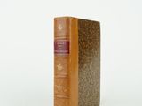 an old book sitting on top of a table next to a white background