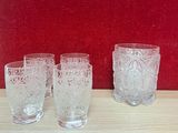 three glasses sitting on a table next to a red wall