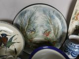 a lot of plates and bowls that are on a table