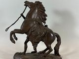 bronze statue of a horse with a rider on its back