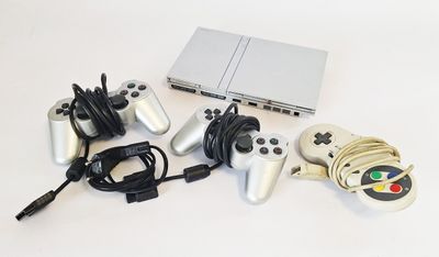 a lot of game controllers and a laptop on the table