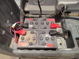 an image of a car ' s battery box with a bunch of wires