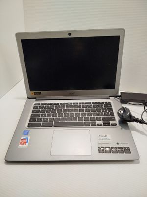 a laptop that is sitting on a table with a charger